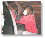 Weatherization insulator, Terry Thomas, fills attic cavities with insulation